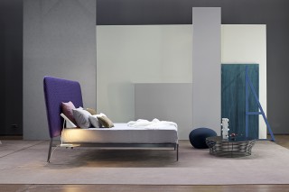 a lightweight metal structure contrasting with a large over-sized head board.