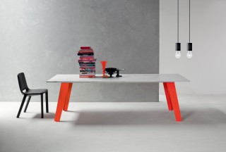 welded table with flashy orange legs and white carrara marble.